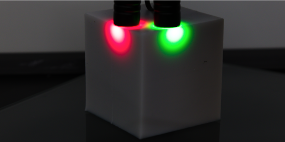 Q-S Optiblox Product Demonstration illuminated with red and green lasers